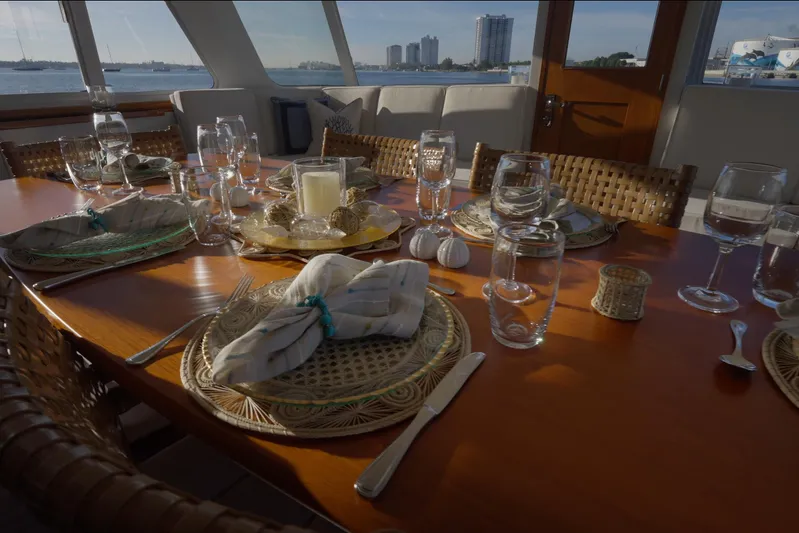 Stoneface Yacht Photos Pics Elegant dining setup on a 1978 Burger Custom yacht with waterfront view.