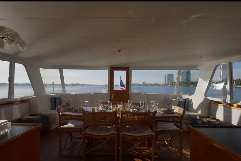 Stoneface Yacht Photos Pics Luxurious 1978 Burger Custom yacht interior with elegant dining setup and panoramic water views.