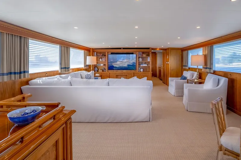 Stoneface Yacht Photos Pics Luxurious yacht interior with elegant seating, wood paneling, and large windows, 1978 Burger Custom model.