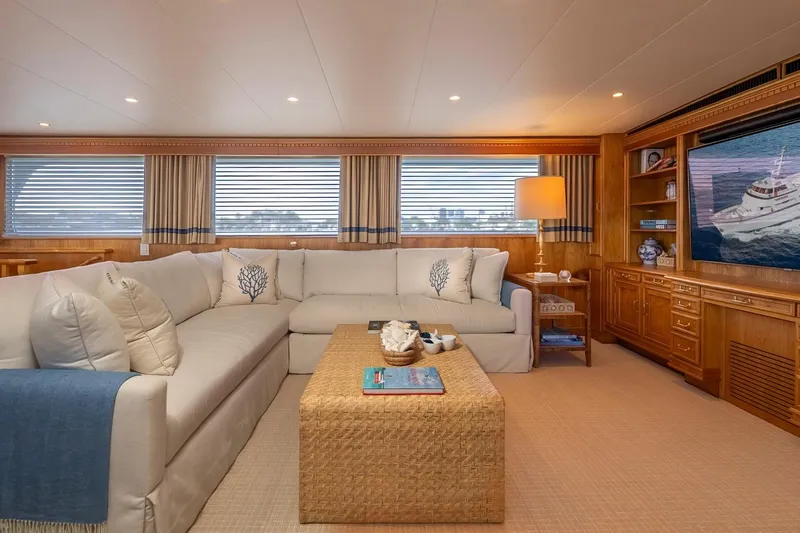 Stoneface Yacht Photos Pics Luxurious yacht interior with cozy seating, elegant decor, and large windows, 1978 Burger Custom.