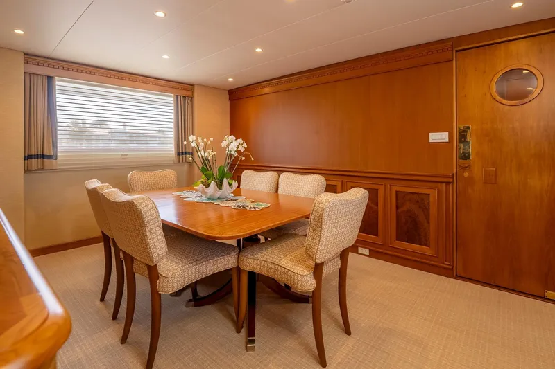 Stoneface Yacht Photos Pics Luxurious yacht dining room with elegant wooden decor, custom table, and plush chairs, 1978 Burger model.
