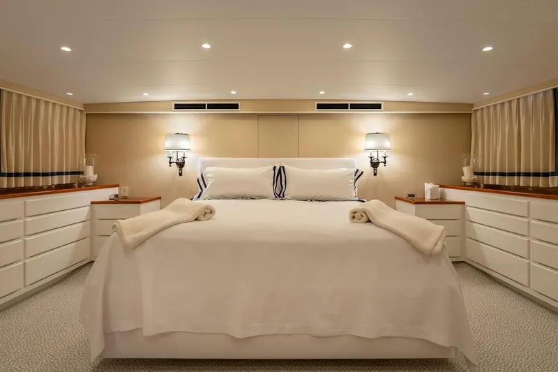 Stoneface Yacht Photos Pics Luxurious yacht bedroom with elegant lighting, white bedding, and ample storage, Burger Custom 1978.