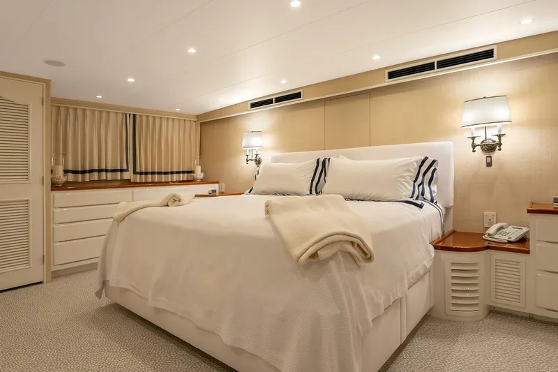 Stoneface Yacht Photos Pics Luxurious yacht bedroom with elegant decor, soft lighting, and comfortable bedding, aboard a 1978 Burger Custom.