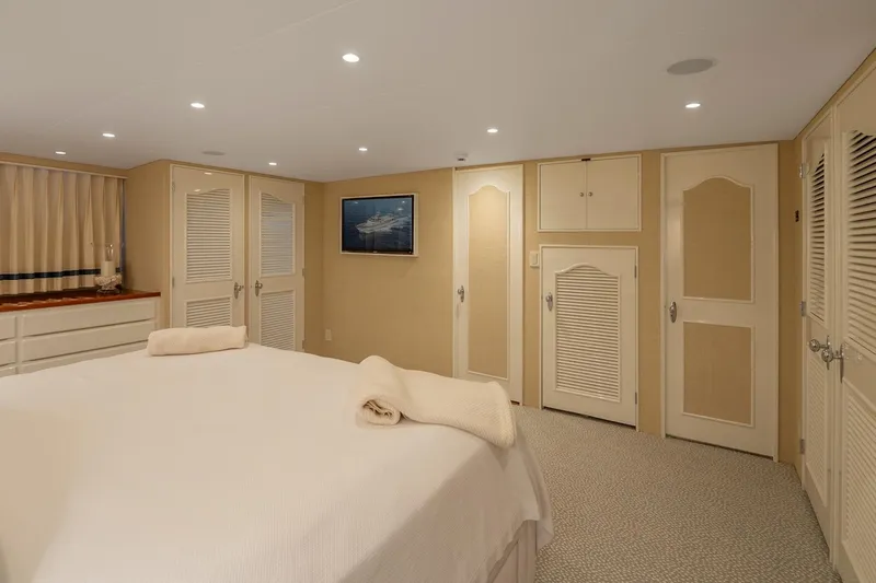 Stoneface Yacht Photos Pics Luxurious yacht bedroom with elegant decor, featuring a comfortable bed and ample storage, 1978 Burger Custom.