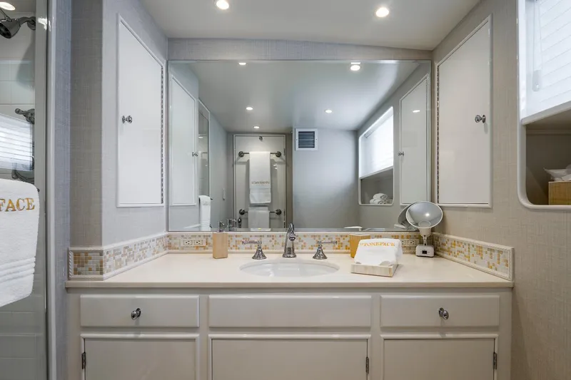 Stoneface Yacht Photos Pics Luxurious bathroom in a 1978 custom Burger yacht, featuring elegant fixtures and ample storage.