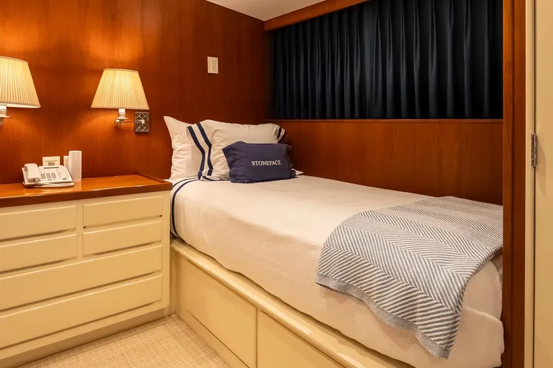 Stoneface Yacht Photos Pics Cozy yacht bedroom with wood paneling, single bed, and soft lighting, 1978 Burger Custom.
