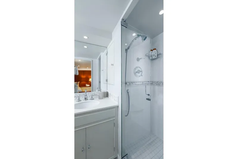 Stoneface Yacht Photos Pics Modern bathroom with glass shower, white vanity, and elegant fixtures.