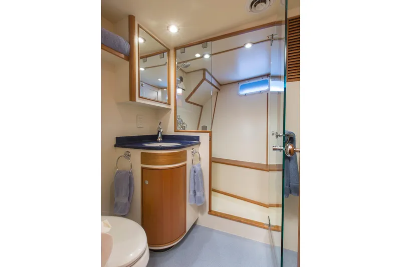 Stoneface Yacht Photos Pics Luxurious yacht bathroom with wooden cabinetry, glass shower, and modern fixtures, 1978 Burger Custom.