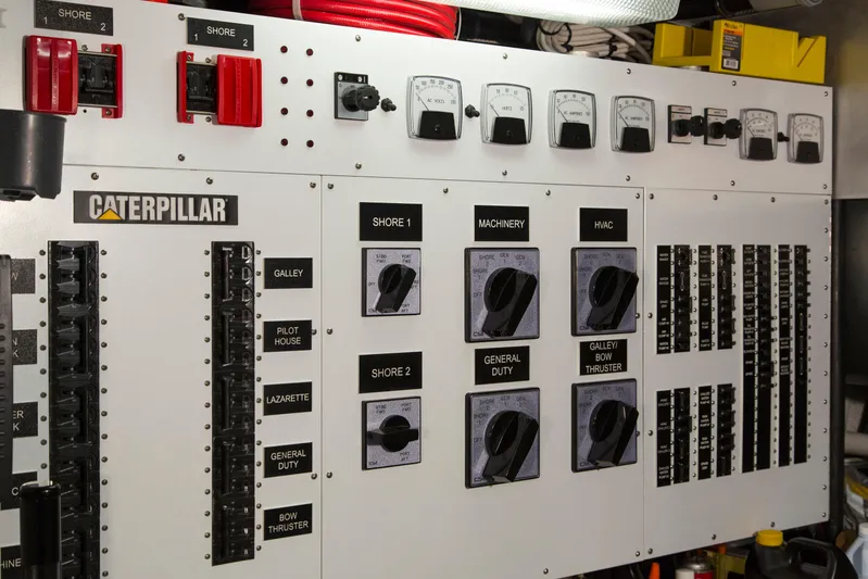 Stoneface Yacht Photos Pics Electrical control panel with switches and meters, featuring Caterpillar branding, in a 1978 Burger Custom.