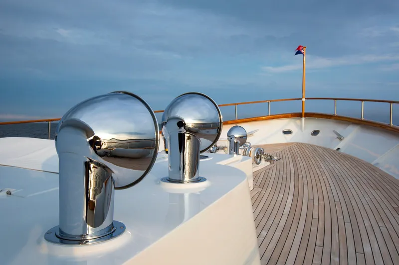 Stoneface Yacht Photos Pics Polished chrome vents on a 1978 Burger Custom yacht deck, with a flag in the background.