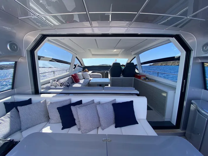 Good Vibes Yacht Photos Pics Luxurious interior of 2020 Pershing 62' yacht with modern seating and ocean view.