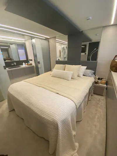 Good Vibes Yacht Photos Pics Luxurious bedroom interior of 2020 Pershing 62' yacht with modern design and elegant bedding.