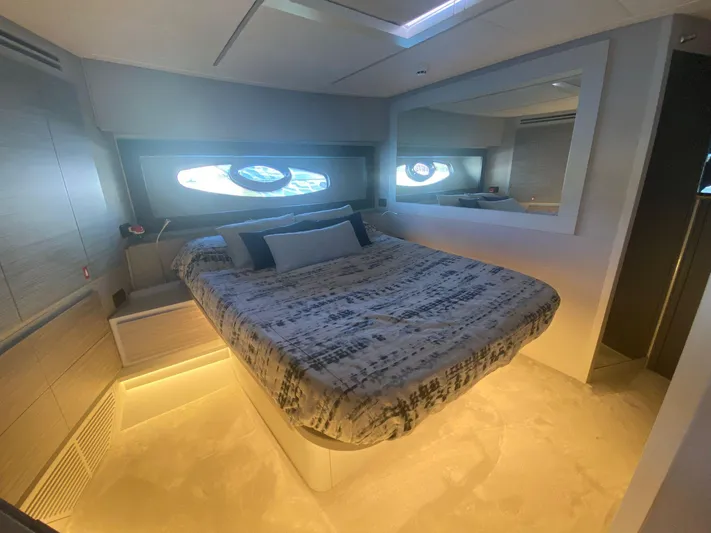 Good Vibes Yacht Photos Pics Luxurious bedroom interior of 2020 Pershing 62' yacht with modern design and ambient lighting.