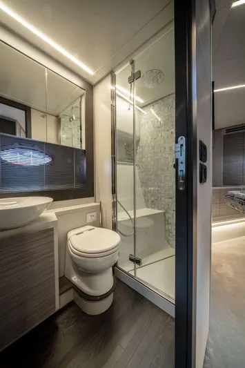 Good Vibes Yacht Photos Pics Luxurious bathroom in 2020 Pershing 62' yacht with modern fixtures and glass shower.