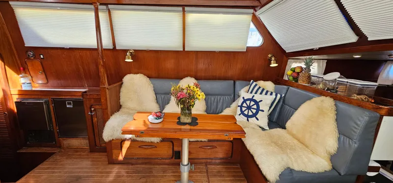 Burgoo Yacht Photos Pics Cozy interior of 1980 Gulfstar 47 Sailmaster with plush seating and nautical decor.