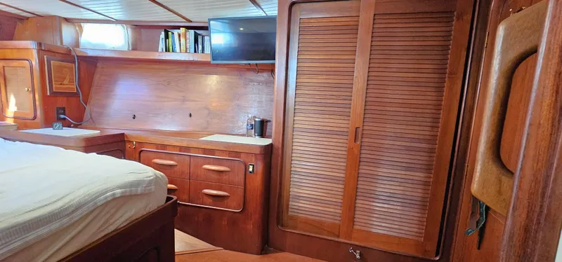 Burgoo Yacht Photos Pics Interior of 1980 Gulfstar 47 Sailmaster with wood cabinetry and cozy sleeping area.