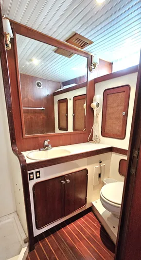 Burgoo Yacht Photos Pics 1980 Gulfstar 47 Sailmaster bathroom with wood accents and modern fixtures.