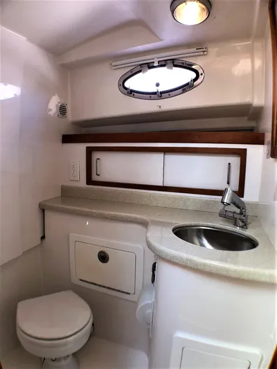 Lady In Blue Yacht Photos Pics 2012 Back Cove 30 yacht bathroom with sink, toilet, and storage cabinets.
