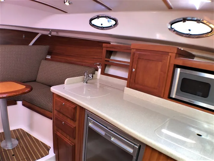 Lady In Blue Yacht Photos Pics Interior of 2012 Back Cove 30 yacht with kitchenette and seating area.