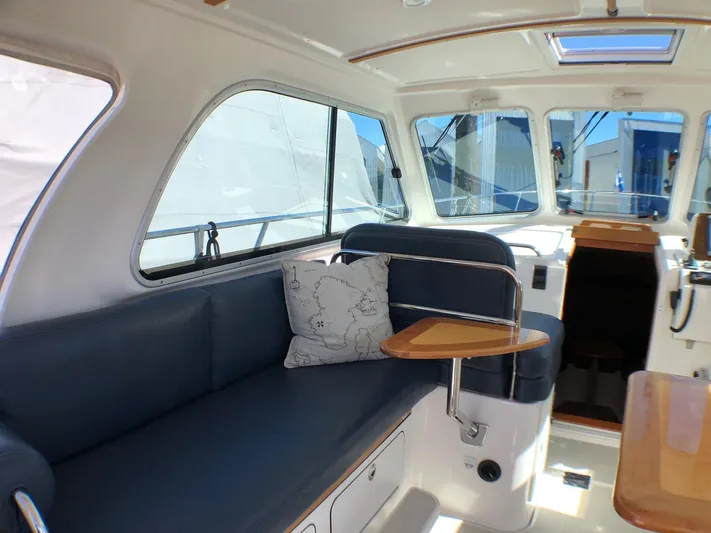 Lady In Blue Yacht Photos Pics Interior of a 2012 Back Cove 30 boat with blue seating and wooden accents.