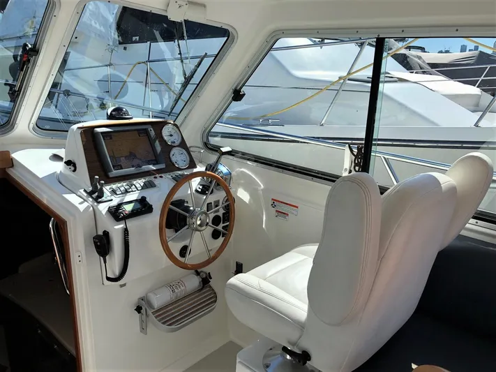 Lady In Blue Yacht Photos Pics Helm of 2012 Back Cove 30 boat with steering wheel and navigation instruments.