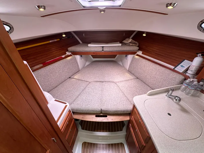 Lady In Blue Yacht Photos Pics 2012 Back Cove 30 boat interior with cozy cabin, wooden accents, and compact kitchenette.