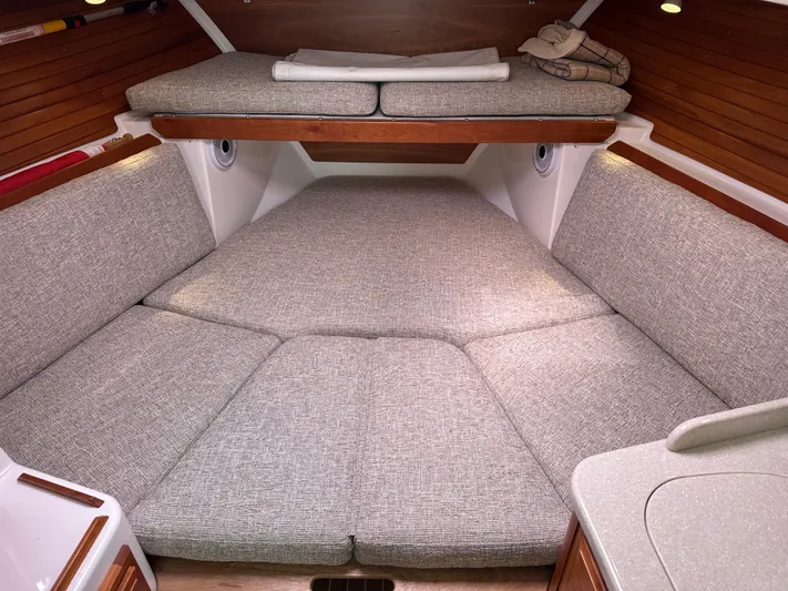 Lady In Blue Yacht Photos Pics Cozy interior cabin of 2012 Back Cove 30 boat with cushioned seating and wooden accents.