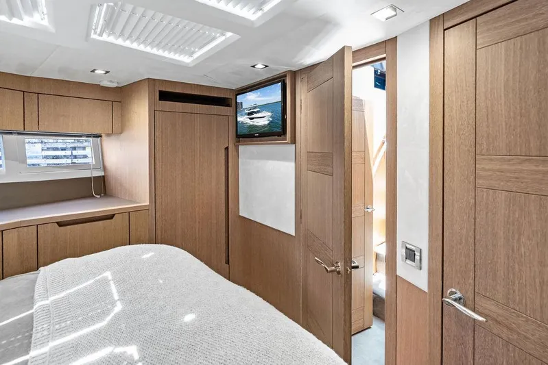 Sea Whisperer Yacht Photos Pics Luxurious interior of 2019 Galeon 500 Fly yacht bedroom with wood finishes and modern design.
