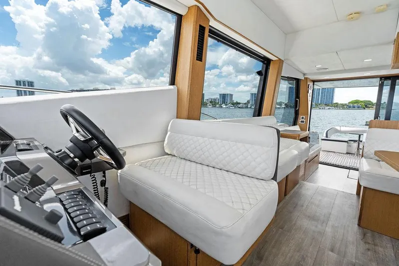 Sea Whisperer Yacht Photos Pics Interior of 2019 Galeon 500 Fly yacht with luxurious seating and scenic water views.