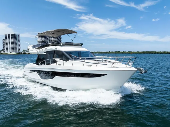 Sea Whisperer Yacht Photos Pics 2019 Galeon 500 Fly yacht cruising on open water under a clear blue sky.