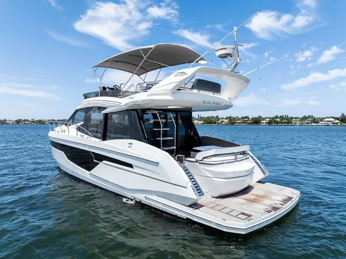 Sea Whisperer Yacht Photos Pics 2019 Galeon 500 Fly yacht on calm water under a clear blue sky.