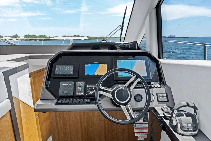 Sea Whisperer Yacht Photos Pics Cockpit of 2019 Galeon 500 Fly yacht with navigation screens and steering wheel.