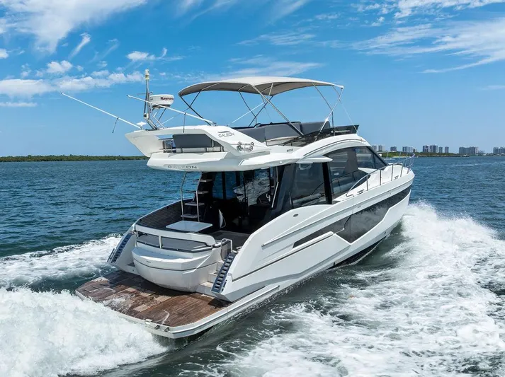Sea Whisperer Yacht Photos Pics 2019 Galeon 500 Fly yacht cruising on open water under a clear blue sky.