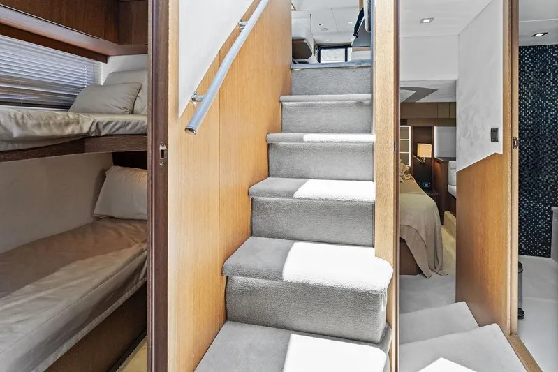 Sea Whisperer Yacht Photos Pics Interior of 2019 Galeon 500 Fly yacht with stairs, bunk beds, and bedroom.