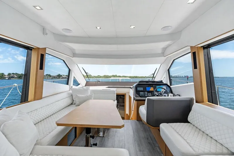 Sea Whisperer Yacht Photos Pics Luxurious interior of 2019 Galeon 500 Fly yacht with panoramic windows and modern seating.