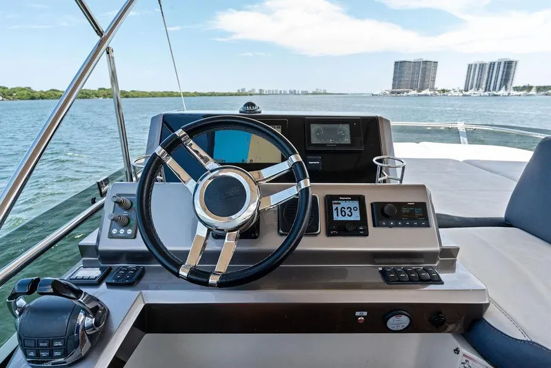 Sea Whisperer Yacht Photos Pics Cockpit view of 2019 Galeon 500 Fly yacht with modern steering and navigation controls.
