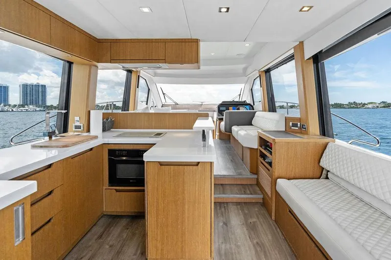 Sea Whisperer Yacht Photos Pics Luxurious interior of 2019 Galeon 500 Fly yacht with modern kitchen and seating area.