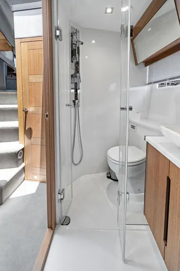 Sea Whisperer Yacht Photos Pics Luxurious bathroom in 2019 Galeon 500 Fly yacht with modern shower and wooden accents.