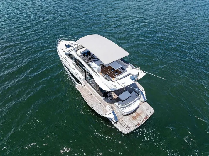 Sea Whisperer Yacht Photos Pics 2019 Galeon 500 Fly yacht cruising on open water, aerial view.