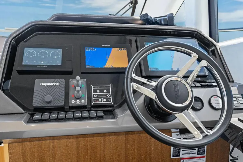 Sea Whisperer Yacht Photos Pics Helm of 2019 Galeon 500 Fly yacht with navigation screens and steering wheel.