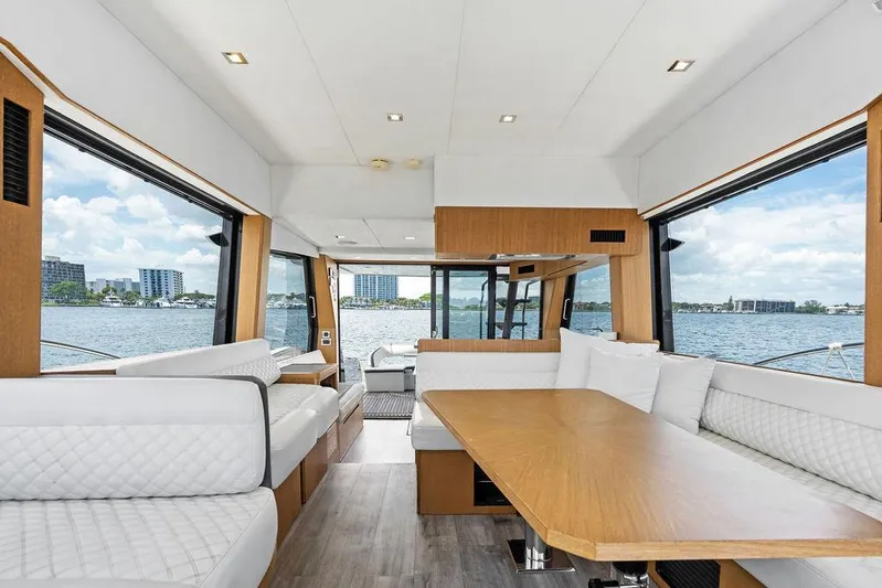 Sea Whisperer Yacht Photos Pics Luxurious interior of 2019 Galeon 500 Fly yacht with panoramic windows and elegant seating.