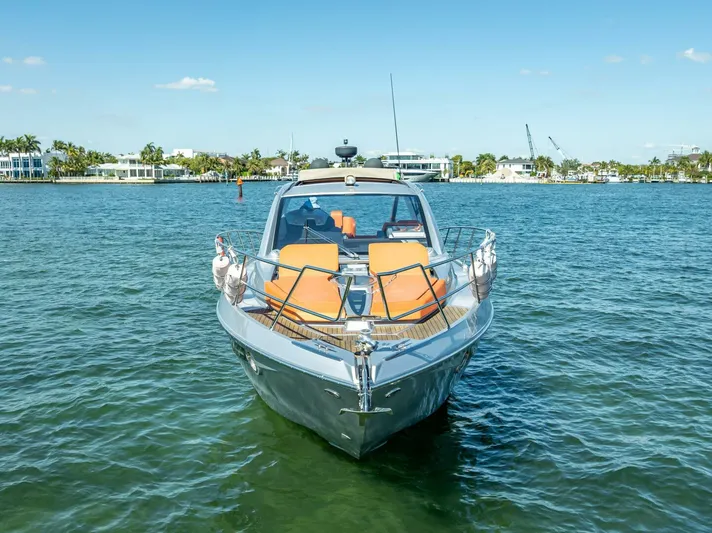 Namaste Yacht Photos Pics 2021 Cranchi M44 yacht on calm water, featuring sleek design and orange seating.