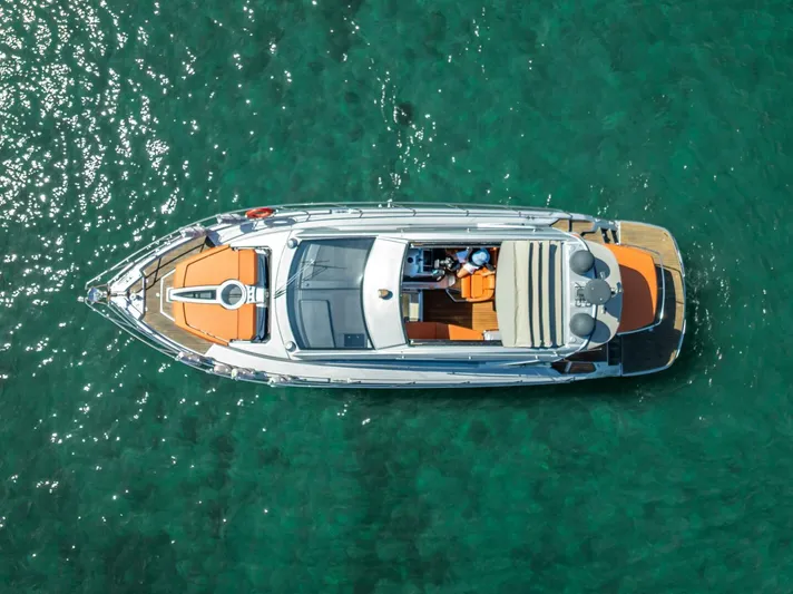 Namaste Yacht Photos Pics Aerial view of 2021 Cranchi M44 yacht on clear turquoise water.