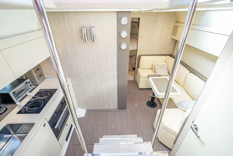 Namaste Yacht Photos Pics Interior of 2021 Cranchi M44 yacht with modern kitchen and cozy seating area.