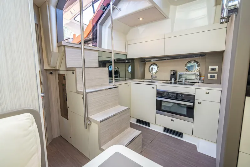 Namaste Yacht Photos Pics Modern kitchen interior of 2021 Cranchi M44 yacht with sleek cabinetry and appliances.