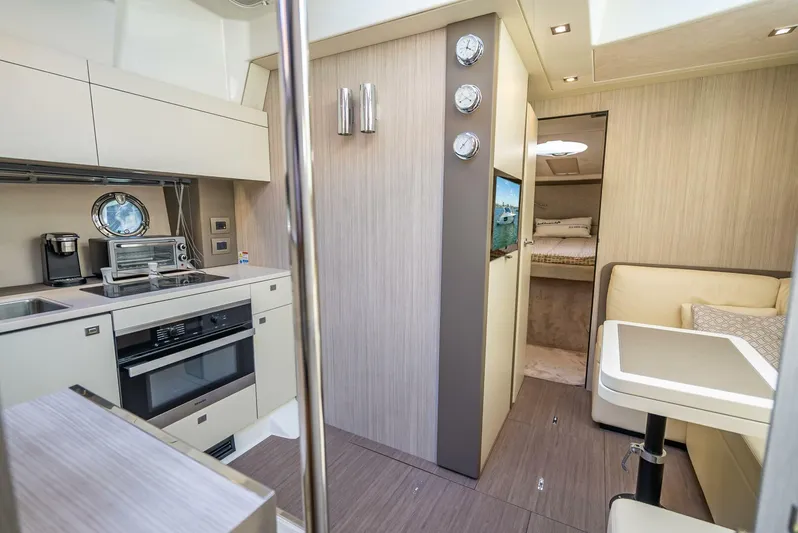 Namaste Yacht Photos Pics Interior of 2021 Cranchi M44 yacht featuring modern kitchen and cozy seating area.