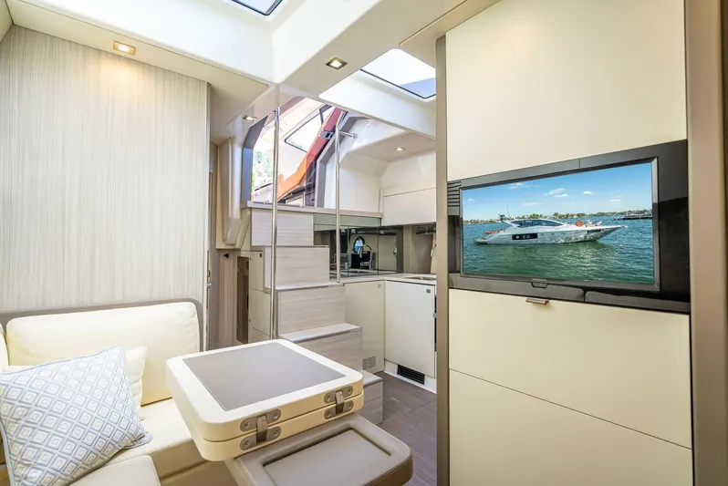 Namaste Yacht Photos Pics Luxurious interior of 2021 Cranchi M44 yacht with modern kitchen and cozy seating area.