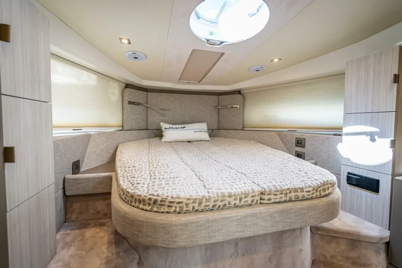 Namaste Yacht Photos Pics Luxurious interior of 2021 Cranchi M44 yacht with elegant bedding and modern lighting.