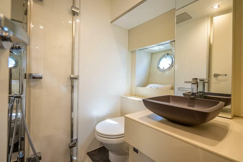 Namaste Yacht Photos Pics Modern bathroom in 2021 Cranchi M44 yacht with sleek fixtures and porthole window.