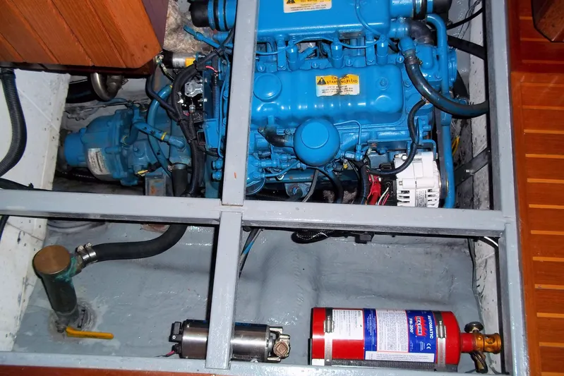 Trouvaille Yacht Photos Pics Engine compartment of a 1984 Slocum 43 sailboat, featuring a blue marine engine.